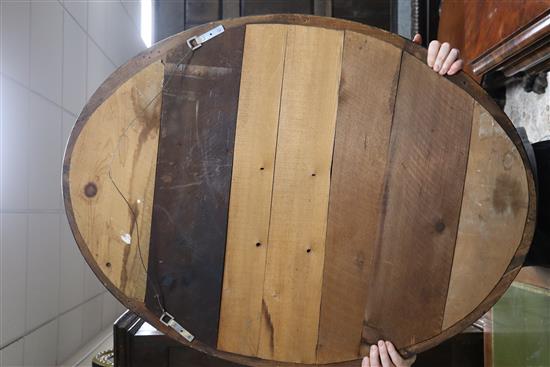 A pair of Irish style oval mirrors with glass-mounted gilt and ebonised frames H.105cm